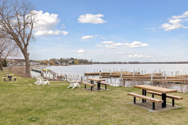 dock area featuring a yard and a water view