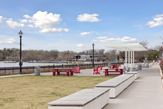 view of community with a water view and a lawn