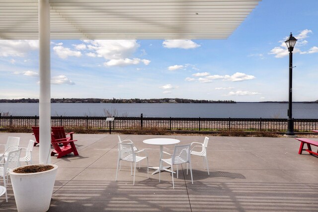 view of patio with a water view