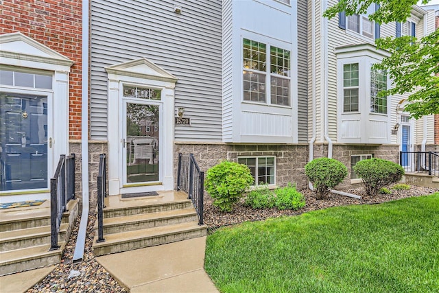 doorway to property featuring a yard