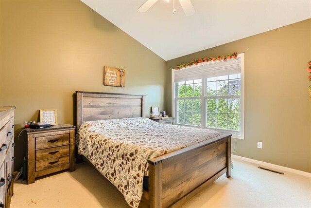 bedroom with high vaulted ceiling, ceiling fan, and light colored carpet