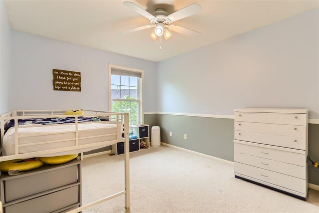 bedroom featuring light carpet and ceiling fan