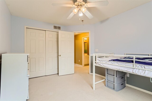 bedroom featuring a closet, ceiling fan, and light colored carpet