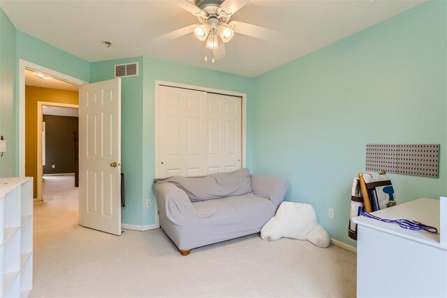 sitting room featuring ceiling fan and carpet flooring