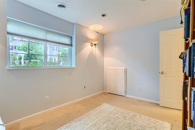 unfurnished bedroom featuring light carpet