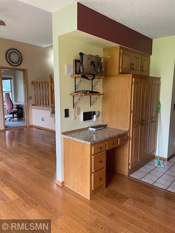 kitchen featuring light hardwood / wood-style flooring and a textured ceiling