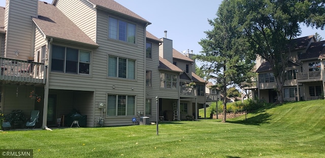 rear view of property with a lawn