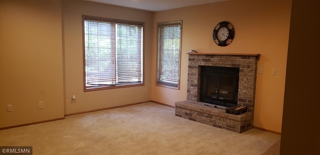 unfurnished living room with light colored carpet and a fireplace