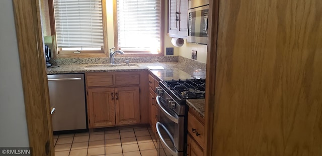 kitchen with sink, light tile patterned floors, and appliances with stainless steel finishes