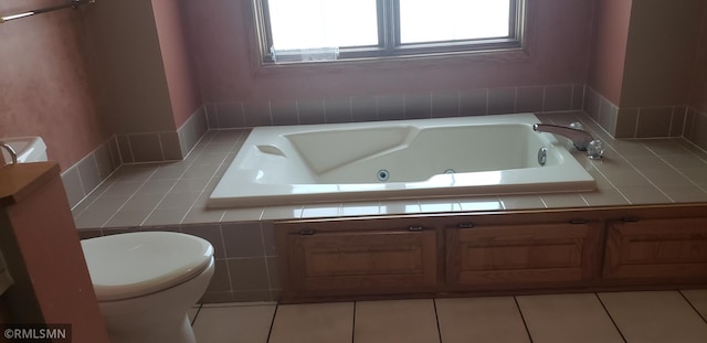 bathroom with a bathing tub, tile patterned floors, and toilet