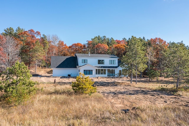 rear view of house featuring covered porch