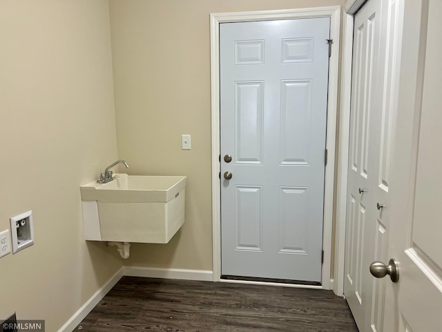 clothes washing area featuring sink, dark wood-type flooring, and hookup for a washing machine