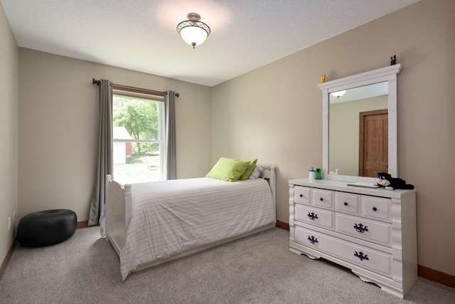 bedroom featuring light carpet