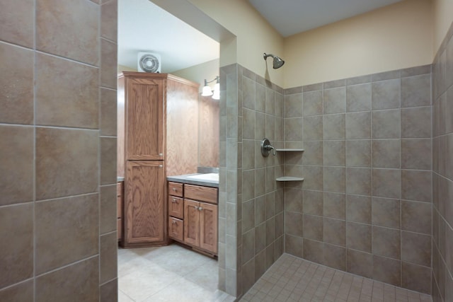 bathroom with vanity and a tile shower