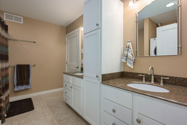 bathroom featuring tile patterned floors, washer / dryer, and vanity