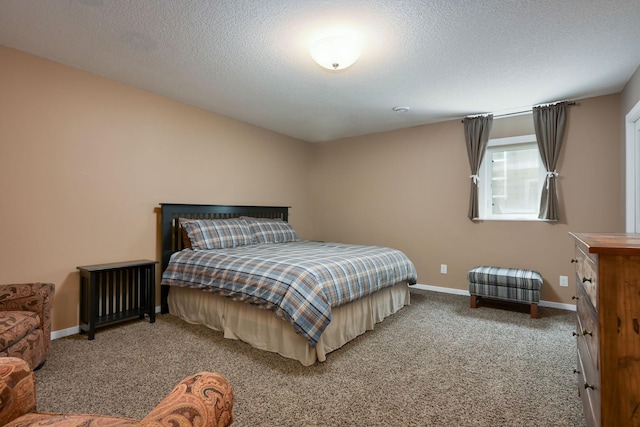 bedroom with a textured ceiling and carpet flooring