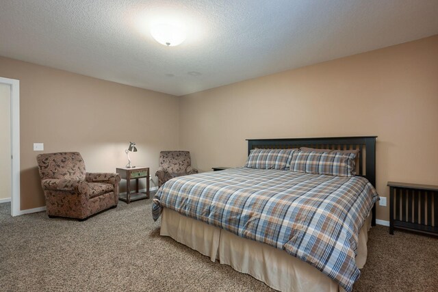 bedroom featuring a textured ceiling and carpet flooring