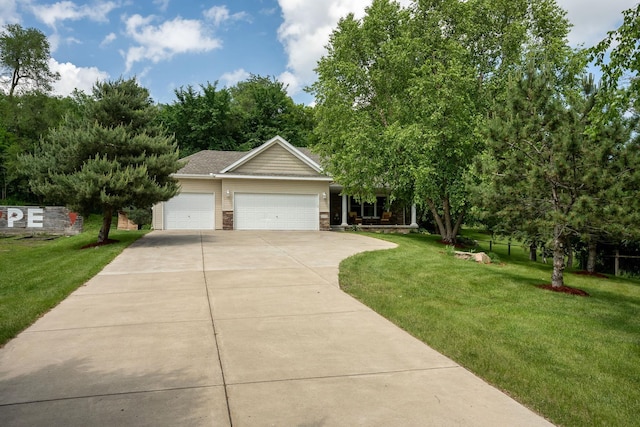 view of front of property featuring a garage and a front lawn