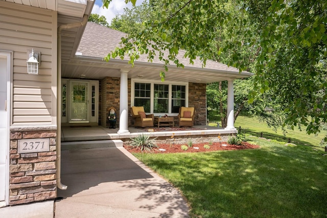 property entrance featuring a yard and covered porch