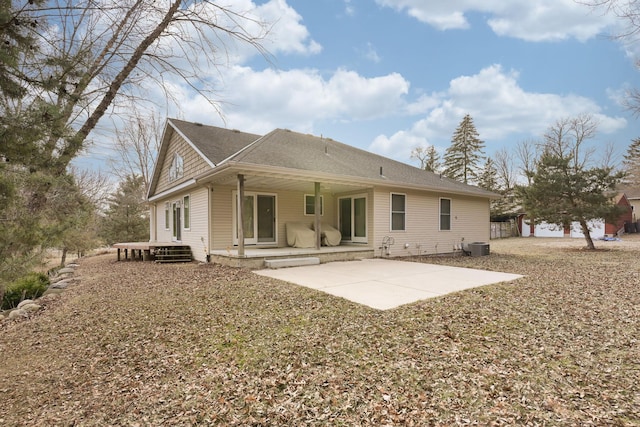 rear view of property featuring central air condition unit and a patio