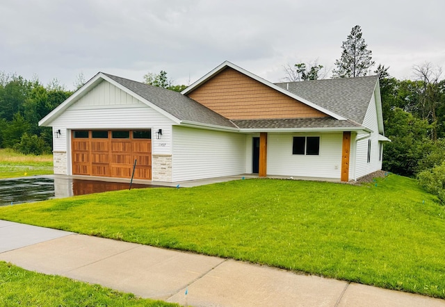 view of front of home featuring a garage and a front lawn