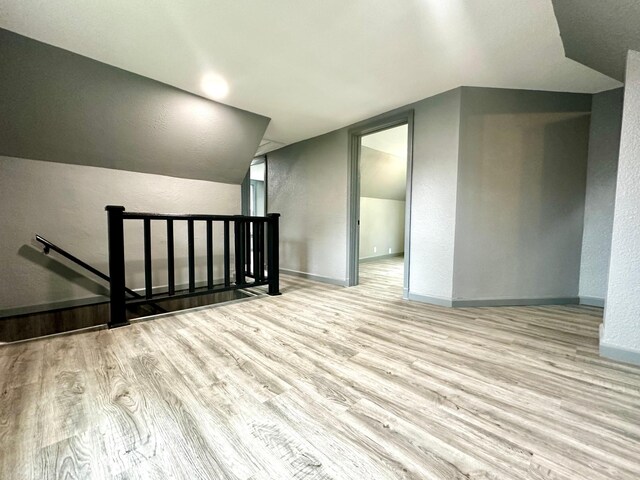 bonus room featuring light hardwood / wood-style floors and lofted ceiling