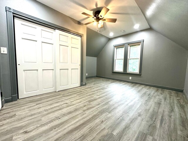 bonus room featuring ceiling fan, light hardwood / wood-style floors, a textured ceiling, and lofted ceiling