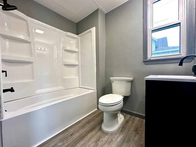 full bathroom with wood-type flooring, toilet, shower / tub combination, and vanity