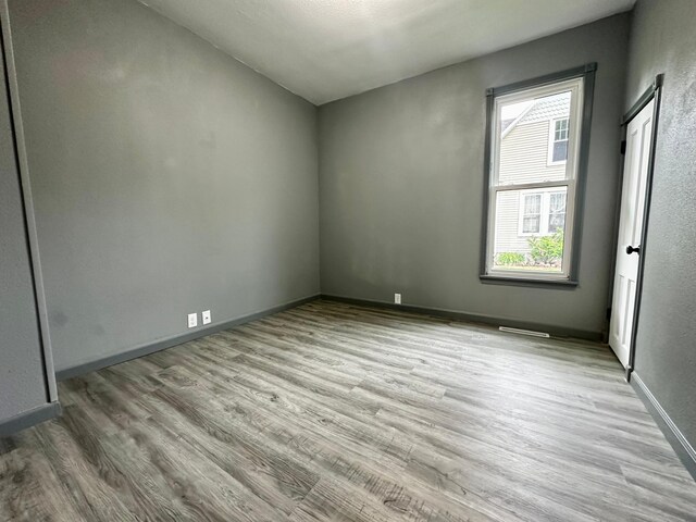 unfurnished room with light hardwood / wood-style floors