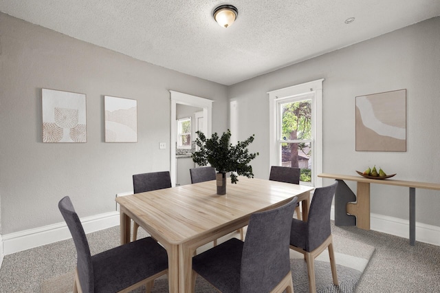 2806 Aldrich Ave N, Minneapolis, MN 55411 - carpeted dining area with baseboards and a textured ceiling