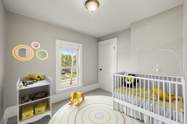 2806 Aldrich Ave N, Minneapolis, MN 55411 - bedroom featuring carpet, baseboards, a crib, and a textured ceiling