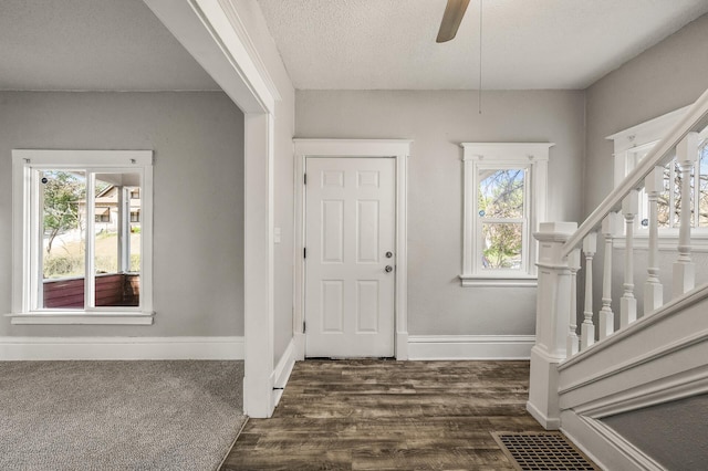 2806 Aldrich Ave N, Minneapolis, MN 55411 - foyer with baseboards, dark wood-type flooring, stairs, a textured ceiling, and ceiling fan