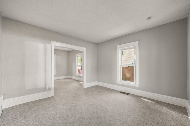 2806 Aldrich Ave N, Minneapolis, MN 55411 - unfurnished room with carpet flooring, baseboards, a textured ceiling, and a smoke detector