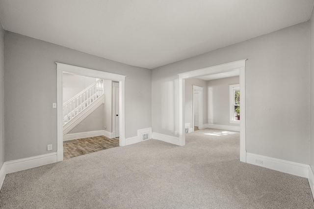 2806 Aldrich Ave N, Minneapolis, MN 55411 - carpeted spare room with stairway and baseboards