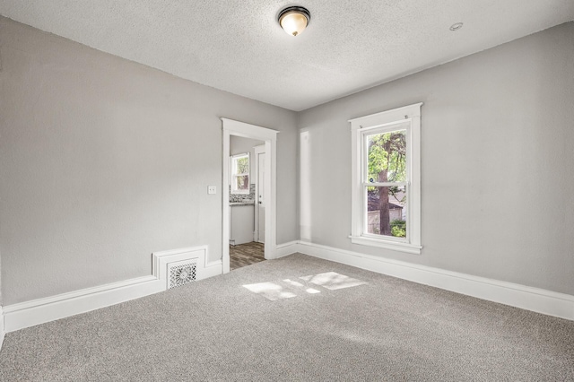 2806 Aldrich Ave N, Minneapolis, MN 55411 - carpeted spare room with a textured ceiling and baseboards