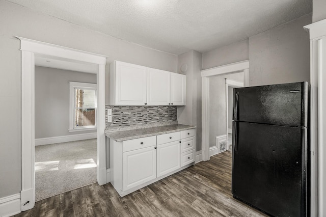 2806 Aldrich Ave N, Minneapolis, MN 55411 - kitchen featuring freestanding refrigerator, light countertops, white cabinetry, dark wood finished floors, and baseboards