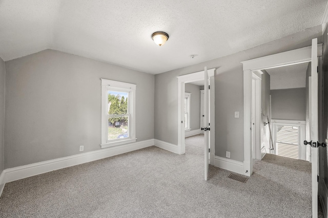 2806 Aldrich Ave N, Minneapolis, MN 55411 - unfurnished bedroom with carpet floors, a textured ceiling, baseboards, and vaulted ceiling