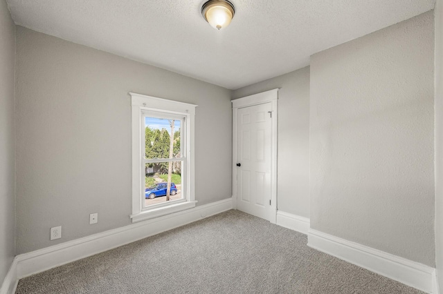 2806 Aldrich Ave N, Minneapolis, MN 55411 - carpeted empty room featuring a textured ceiling and baseboards