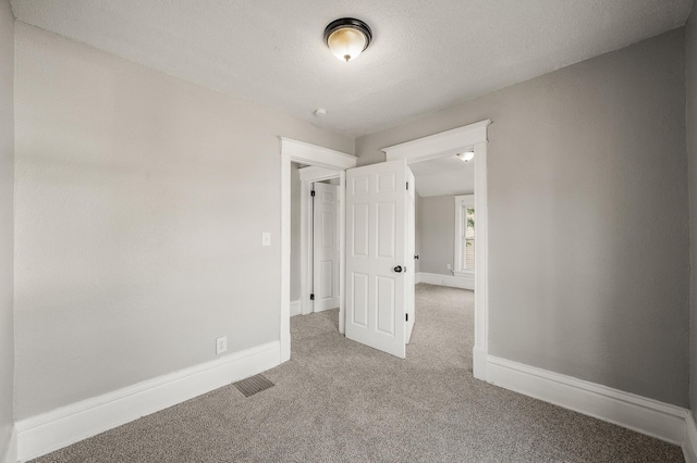 2806 Aldrich Ave N, Minneapolis, MN 55411 - unfurnished room with carpet flooring, baseboards, and a textured ceiling