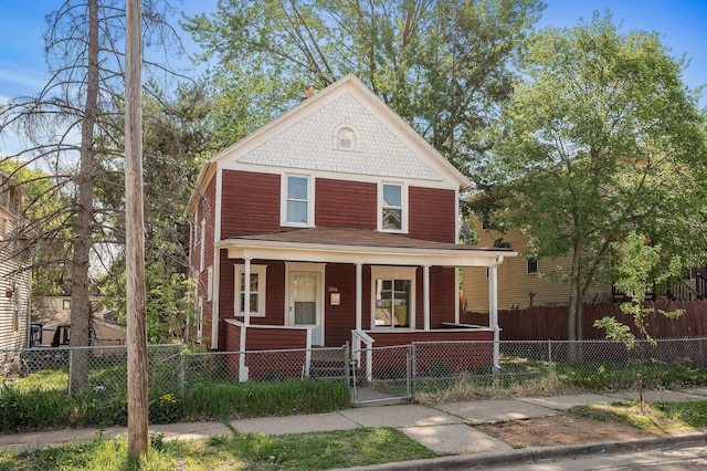 2806 Aldrich Ave N, Minneapolis, MN 55411 - victorian-style house with covered porch, a gate, and a fenced front yard