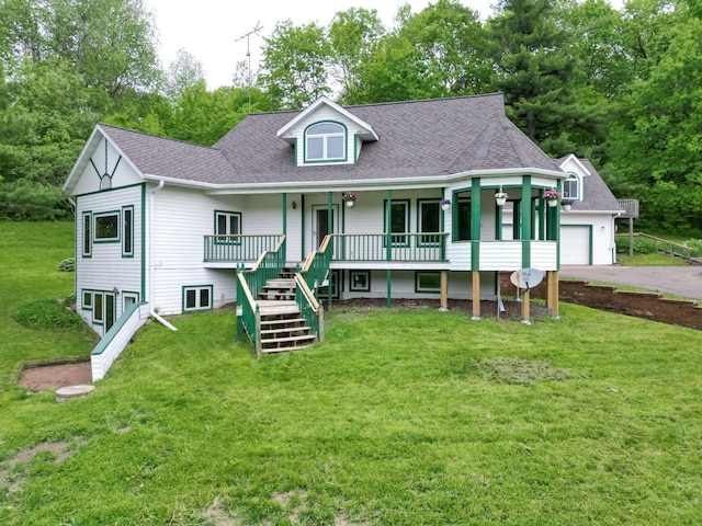 view of front of home with a porch, a garage, and a front yard