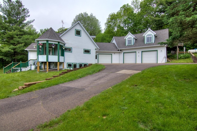 view of front facade with a garage and a front lawn