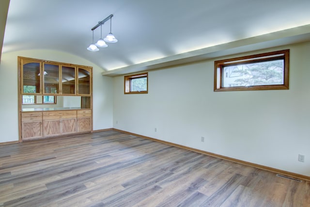 interior space with hardwood / wood-style floors and rail lighting