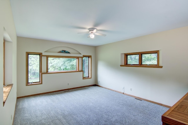 empty room featuring light carpet and ceiling fan