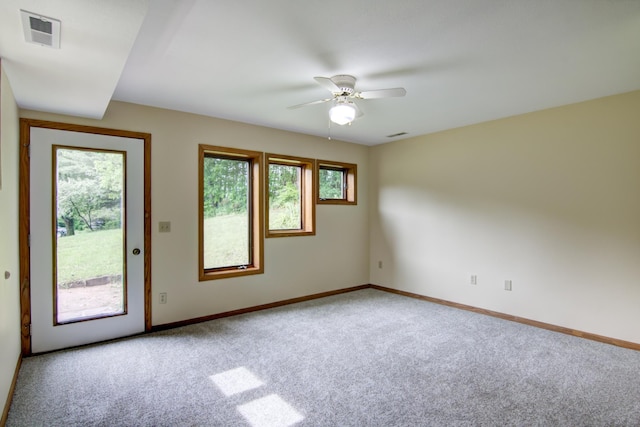 empty room featuring carpet flooring and ceiling fan