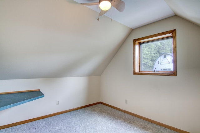 bonus room featuring lofted ceiling, carpet flooring, and ceiling fan