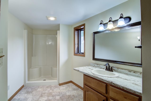 bathroom with a shower, vanity, and tile patterned floors