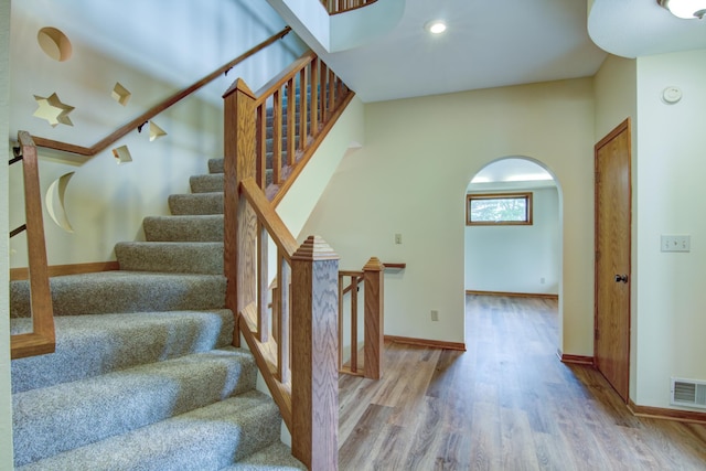 staircase with track lighting and light wood-type flooring