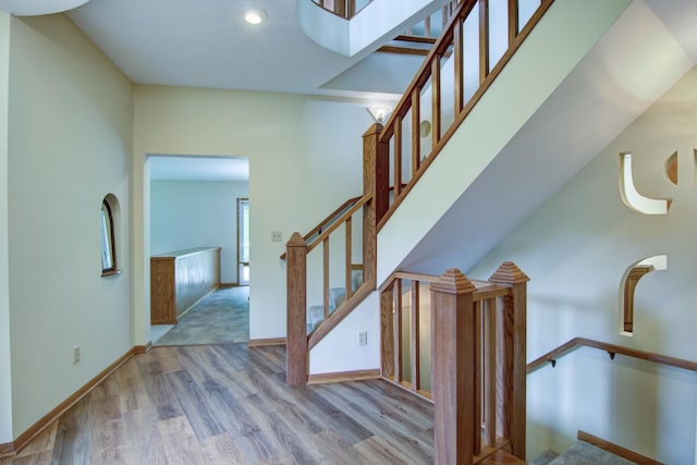 staircase featuring wood-type flooring