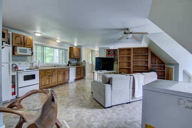 living room with light colored carpet, sink, and ceiling fan